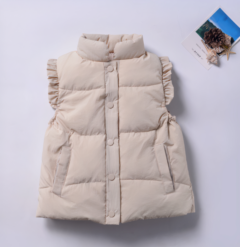 Een beige mouwloos donsjack voor een klein meisje is afgebeeld op een paarse achtergrond naast een foto van een vakantie.